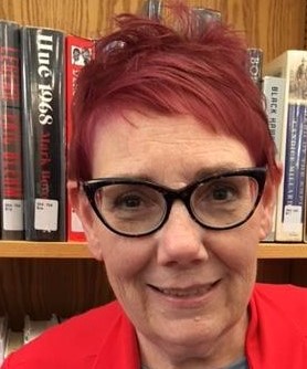 A person with red hair Description automatically generated with low confidence